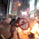 A protestor uses a shield to cover himself as he faces policemen in Hong Kong, Saturday, Aug. 31, 2019.